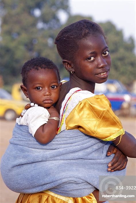 African Girl Carrying Baby On Stock Photo