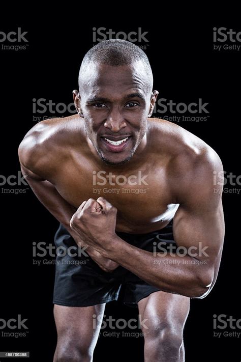 Portrait Of Muscular Man Flexing Muscles Stock Photo Download Image