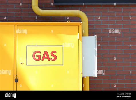 Gas Distribution System With Pipe Near Red Brick Wall Outdoors Space