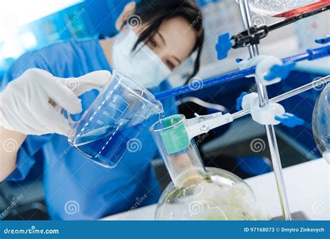 Selective Focus Of Liquid Being Poured Into The Flask Stock Image