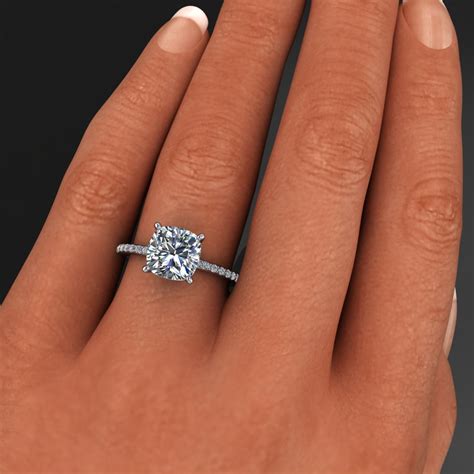 Woman wearing engagement ring on fourth finger. eliza ring - 2.4 carat cushion cut NEO moissanite ...