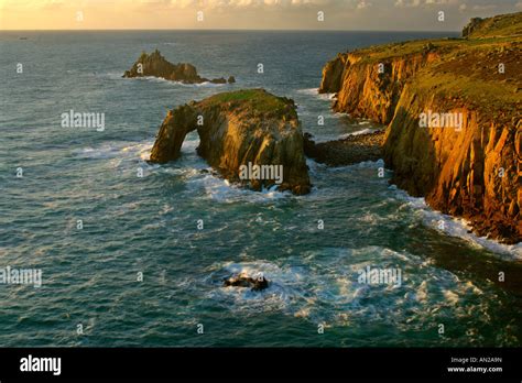 Rugged Coastline With Rock Arch In Last Evening Light Lands End