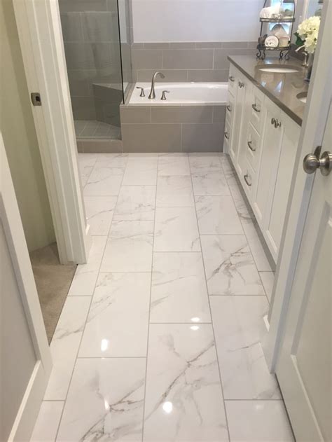 Small bathroom with carrara marble hex tile on floor, ceramic subway tile on shower walls, marble counter top, marble bench seat, marble trimmin. I like shiny tile. | the loo in 2019 | Bathroom flooring ...