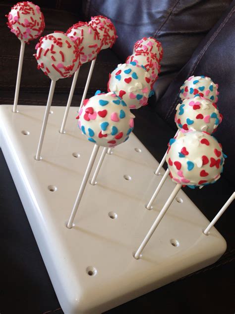 Cake Pops With Sprinkles Are Arranged On A White Tray In The Shape Of