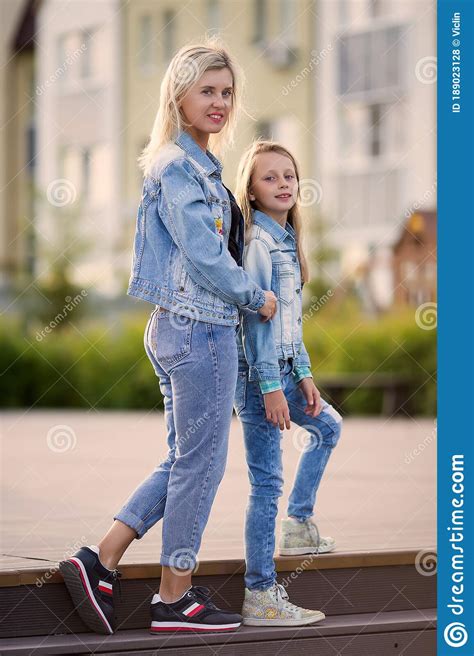 Happy Mother And Daughter 8 9 Years Old Walk In The Park In The Summer The Concept Of A Happy