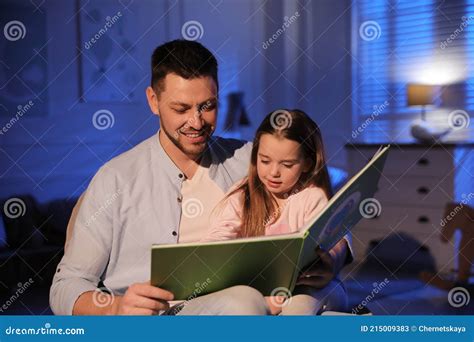 father reading bedtime story to his daughter at home stock image image of little love 215009383