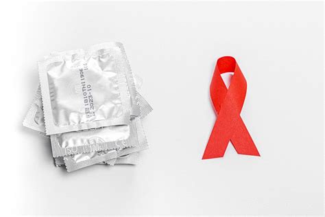 Condoms And Red Ribbon On A White Background The Concept Of Protection Against Sexually