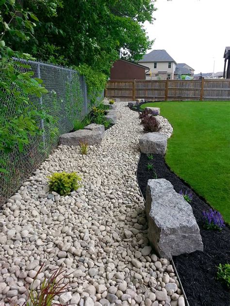 Landscaping with a dry stream and using river rock to accent your garden. Backdrop Garden: 1-3 River Rock, Black Beauty Mulch - Zarcon Landscape - The Landscape Depot