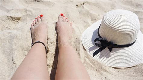 Summer Holiday Fashion Concept Tanning Woman Legs And Sun Hat At The