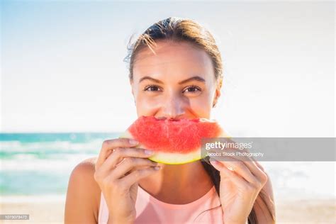 Young Woman Eating Watermelon At The Beach High Res Stock Photo Getty