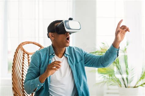 Surprised Amazed Millennial African American Guy In Vr Glasses Plays In