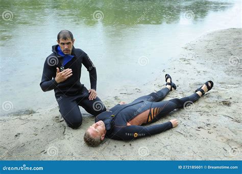 Lifeguards Showing Position Of Drowning Body Before Doing Mouth To