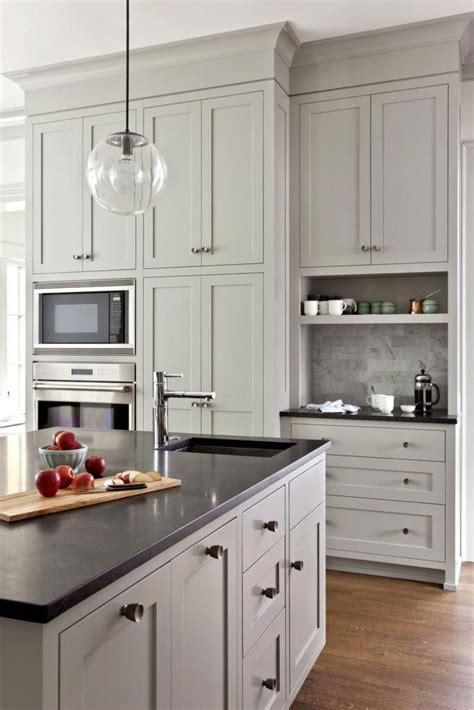 We loved the shade of the gray in this grey shaker kitchen cabinet! Tudor Reimagined • Projects • 3north - lovely pale gray kitchen with floot to ceiling cabinets # ...