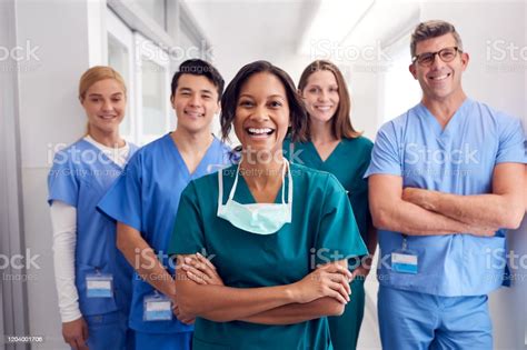 Portrait Of Laughing Multicultural Medical Team Standing In Hospital