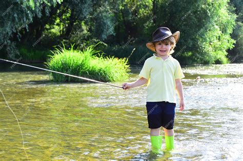 Premium Photo Little Boy Catching A Fish Children Fishing Boy Fishing