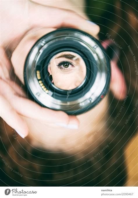 Young Womans Eye Looking Through A Camera Lens A Royalty Free Stock