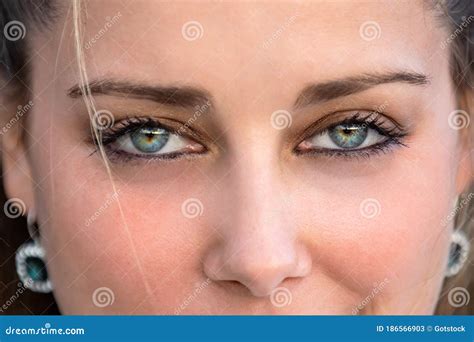 Close Up Female Portrait On Intense Piercing Blue Eyes Confident