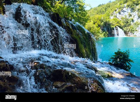 Small Waterfall Closeup And Azure Limpid Lake In Plitvice Lakes