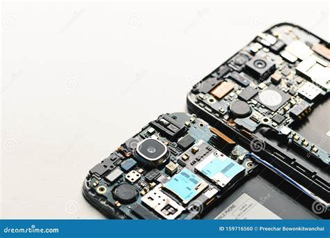 The Inside Of The Smartphone S Motherboard And Tools Lay On The White