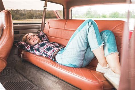 Beautiful Babe Woman Lying On Back Seat Of Vintage Car In Field Stock Photo Dissolve