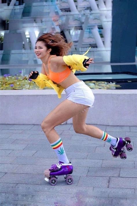 A Woman Rollerblading Down The Street In An Orange Top And White Shorts With Colorful Socks