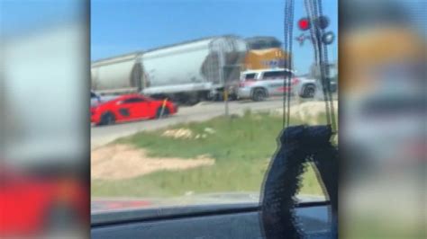 police car hit by speeding train after driving around lowered arm cnn video
