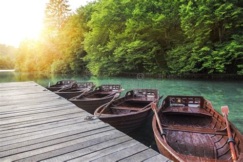 Wooden Boats At The Pier On The Lake In The Evening Light Stock Photo