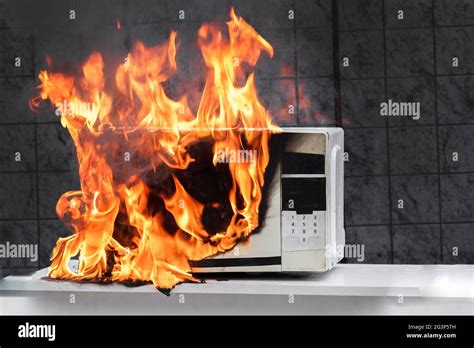 Microwave Oven White In Fire Front View Electrical Appliances Caught