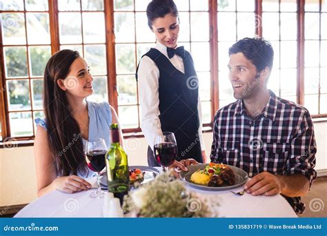 Waitress Serving Food Plate On Customers Table Stock Image Image Of