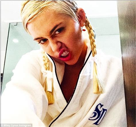 Miley Cyrus Snarls As She Shows Off Her Joke Teeth And Blonde Braids