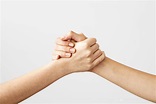 Two hands holding each other strongly | Gedenkstättenfahrten