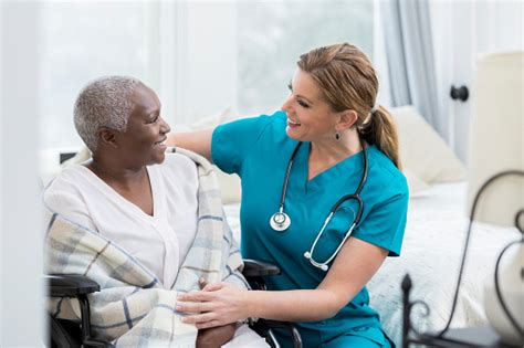 Caring Nurse Talks With Senior Female Patient Stock Photo Download