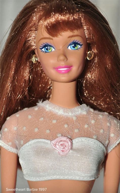 a close up of a barbie doll with blue eyes