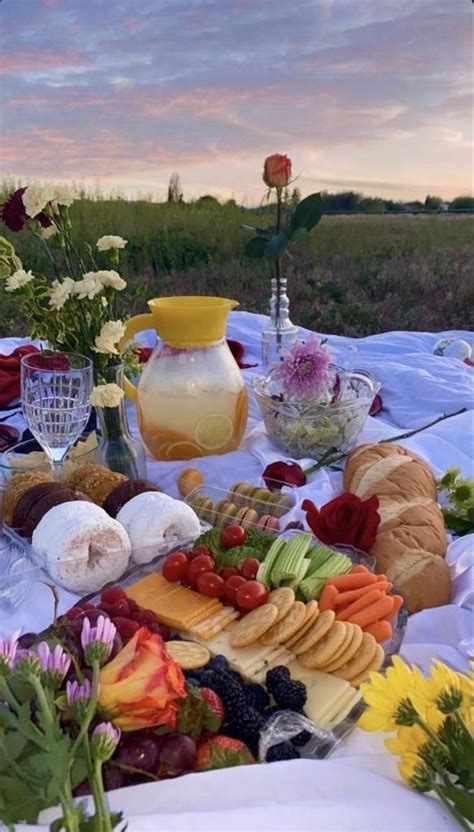 A Table Topped With Lots Of Different Types Of Food And Flowers On Top