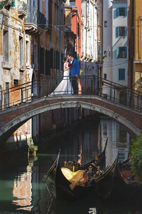 The Essency Of Romance In Venice A Kissing Inlove Couple On A Bridge