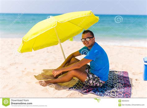 The Man Under A Solar Umbrella On Beach Royalty Free Stock Photo
