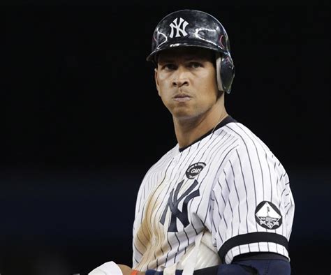 A Baseball Player Wearing A New York Yankees Uniform And Holding A Bat
