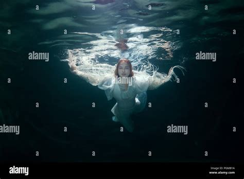 Portrait Of A Beautiful Woman In A White Dress Under The Water Stock