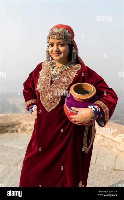 Portrait Of An Indian Woman Wearing Ethnic Kashmiri Dress And Carrying