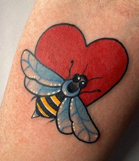 A Heart Shaped Tattoo With A Bee On It