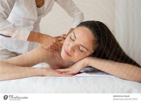 Beautiful Topless Female Customer Smiling Lying Comfortably On Bed And Receiving Back Therapy