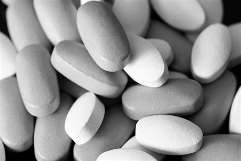 colored oblong pills on the isolated background - grey scale - AlixaRx