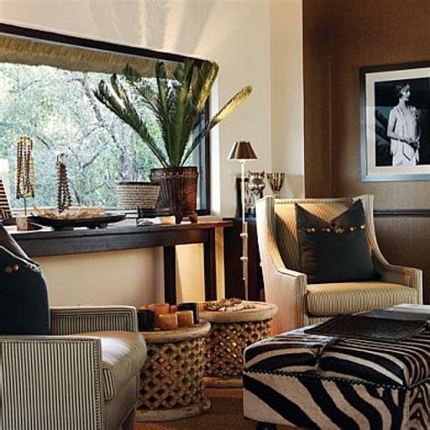 The warmth of the colors used, the bold accessories and rich earthy tones all add to the attraction and bring this stunning theme to life. Jungle Themed Living Room Decor | African themed living ...