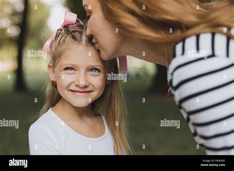 Loving Blonde Haired Mother Kissing Her Cute Prebabe Girl Stock Photo Alamy