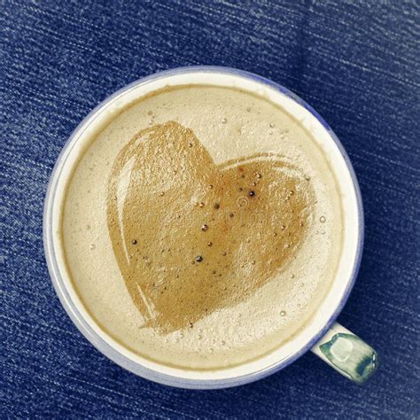 Cup Of Cappuccino Coffee With Foam In The Form Of Heart On Blue Stock