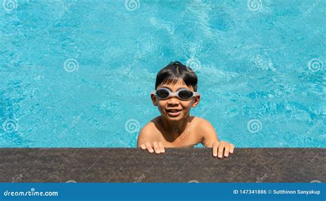 Happy Boy In Swimming Pool Standing At The Edge Royalty Free Stock