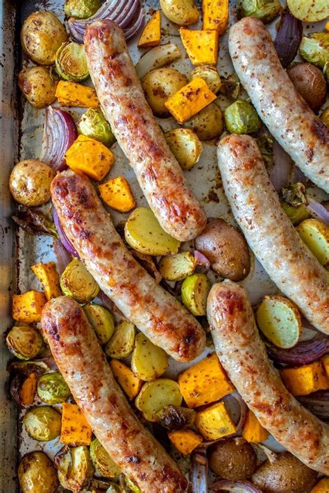 Sausages Potatoes And Squash On A Baking Sheet