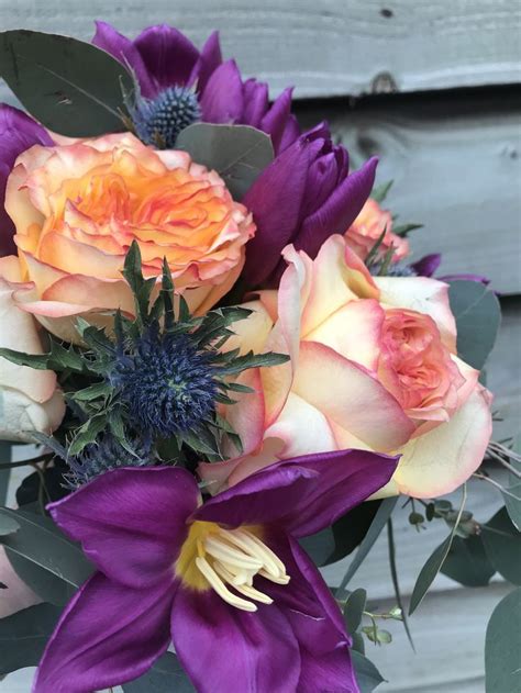 Wedding rings with rose flowers. Bright and cheerful hand tied spiral wedding bouquet ...