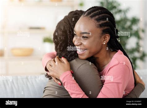 Pretty African American Girlfriends Hugging At Home Stock Photo Alamy