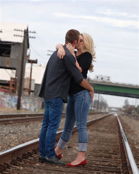Engagement Photo A Kiss On The Railroad Tracks Railroad Tracks Engagement Photos Photo Ideas